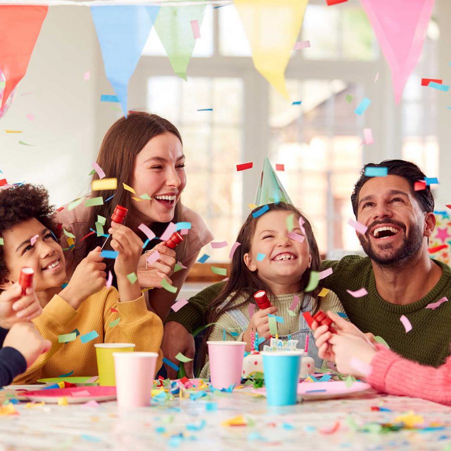Girl With Parents And Friends At Home Celebrating Birthday Firin